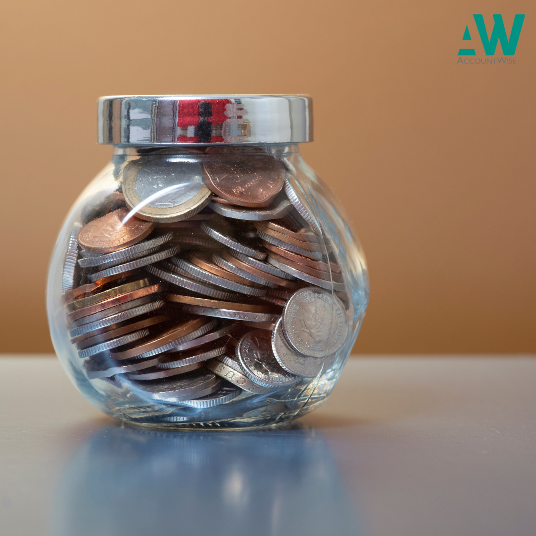 A glass jar with money to represent savings as post is talking about ISAs
