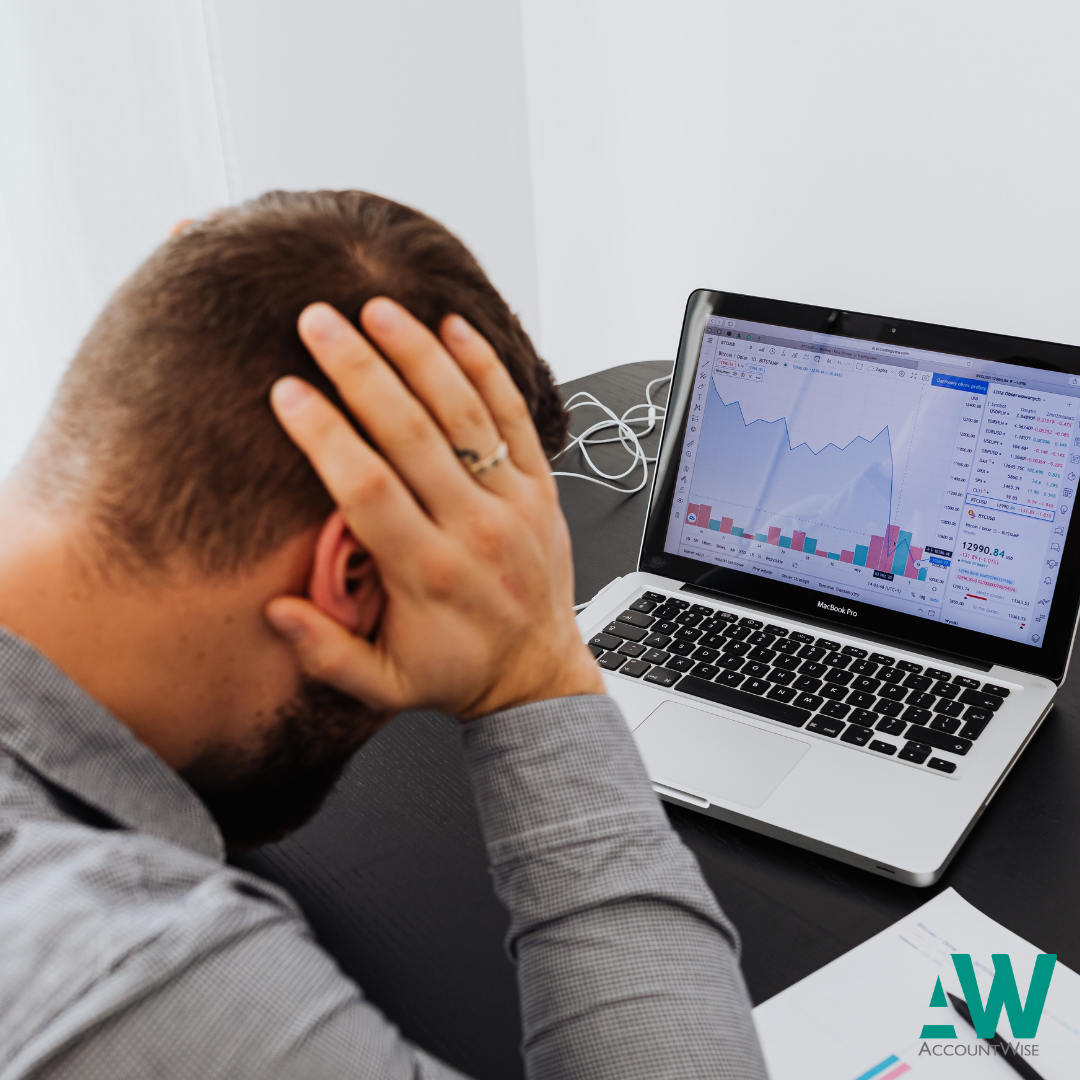 Man holding head worried about trading losses